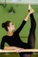 Elegant beautiful ballerina with a perfect body doing stretching exercise.