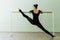 Elegant beautiful ballerina with a perfect body doing stretching exercise.