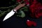 Elegant beautiful knife and a bouquet of roses.