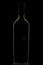 Elegant black corked wine bottle reflected on black background.