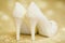 Elegant bridal white shoes with rhinestones, high heels, closeup