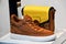 Elegant brown sneaker with yellow handbag