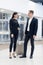 Elegant business couple standing with suitcase and airplane tickets at the waiting hall in the airport. Business travel