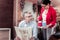 Elegant business lady in a red jacket offering coffee to her colleague