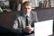 Elegant businessman sitting at desk with laptop