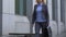 Elegant businesswoman walking by office building, governmental institution