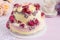 Elegant cake decorated with burgundy cream rose flowers