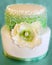 Elegant cake with white icing and green frills