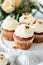 Elegant Carrot Cupcakes Topped With Cream Cheese Frosting on a Ceramic Stand