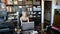 Elegant and cheerful woman works on laptop in office where a lot of books. Cheerful young beautiful woman looking at