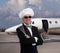 Elegant chef posing in front of a private jet