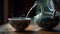 Elegant Chinese Porcelain Teapot Pouring Steaming Green Tea into Cup on Wood