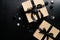 Elegant Christmas present boxes and balls on black background. Flat lay, top view. Christmas surprise, New Year gift box concept