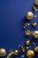 Elegant Christmas vertical banner mockup. Golden balls, decorations, garland lights on blue background. New Year poster template