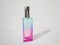 Elegant colored purple with blue rectangular perfume bottle. Cosmetic container with color gradient. Pink perfume botlle