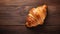 Elegant Croissant On Wooden Table - High Resolution Image