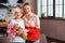 Elegant dame with pink tulips being cuddled by beautiful daughter-in-law.