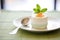 elegant dessert: coconut yogurt panna cotta with a mint leaf