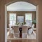 Elegant dining room through curved arch doorway