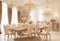 An elegant dining room with a long wooden table, surrounded by upholstered chairs,