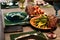 Elegant dining setup with vintage blue glassware; a plate of fresh vegetables adds a touch of health consciousness