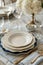 Elegant dinnerware set arranged on a marble table with striped linen