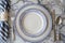 Elegant dinnerware set on a marble background with napkin and cutlery