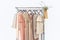 Elegant dress, jumper, trousers and other fashion outfit pastel beige color. Spring cleaning home wardrobe