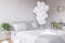 Elegant dresser in classy grey bedroom with king size bed and bunch of white balloons