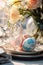 Elegant Easter Table: Colorful Eggs, Lace Tablecloth, and Botanical Wallpaper