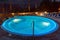 Elegant empty water pool with blue water at night