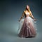 Elegant fashion. Stunning woman in elegant long dress in studio. Luxury evening fashion. Glamour fashion model. Elegance