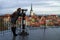 Elegant and fashionable tourist woman looking through binoculars at old Tallinn city sightseeing.