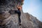 Elegant female extreme climber looking in camera