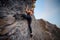 Elegant female extreme climber looking in camera