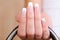 Elegant female fingers with french manicure