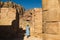 Elegant female tourist in trendy hat and sky-blue dress explore lost rock city Petra. Romantic mood. Atmospheric place. Summer fas