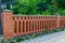 An elegant fence made of brick columns. Background with copy space for text