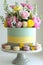 Elegant Floral Cake Decorated with Macarons, Vibrant Roses, and Spring Flowers