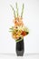 Elegant flower arrangement in beautiful vase isolated in a bright white studio