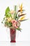 Elegant flower arrangement in beautiful vase isolated in a bright white studio