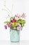 Elegant flower arrangement in beautiful vase isolated in a bright white studio