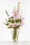 Elegant flower arrangement in beautiful vase isolated in a bright white studio