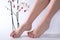 Elegant Foot Care: Young Beautiful Female Feet with Red Nails Polish