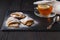 Elegant fresh breakfast: tea with lemon and pastries