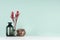 Elegant fresh home decor with red bizarre branch in black glass vases, decorative natural brown sheaf of twigs in style green mint