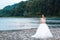 Elegant gentle stylish bride near river or lake. Wedding couple in love