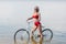 elegant girl in red vintage bikini posing with bike