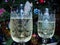 Elegant glasses with champagne on the background of a Christmas tree. Champagne bubbles in the glass. A Festive atmosphere.