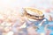 Elegant Gold Wedding Ring on White Pillow with Rose Petals and Bokeh Lights